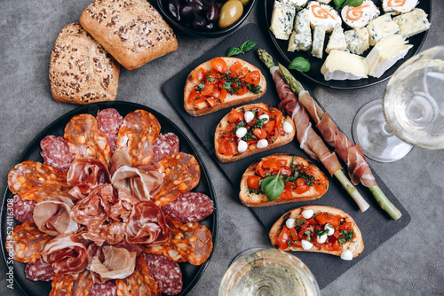 Food prosciutto ham, salami, olives and bread. cheese on a board parmesan, pecorino. Charcuterie board.	
