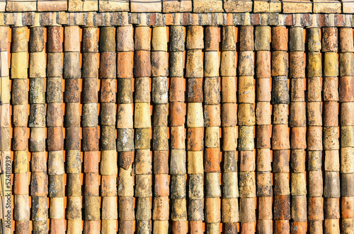Closeup surface of old weathered ceramic tiles covering building roof