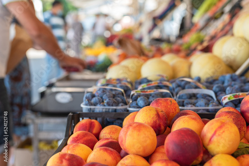 Fototapeta Naklejka Na Ścianę i Meble -  Fresh fruit on stand of food market with blurred background