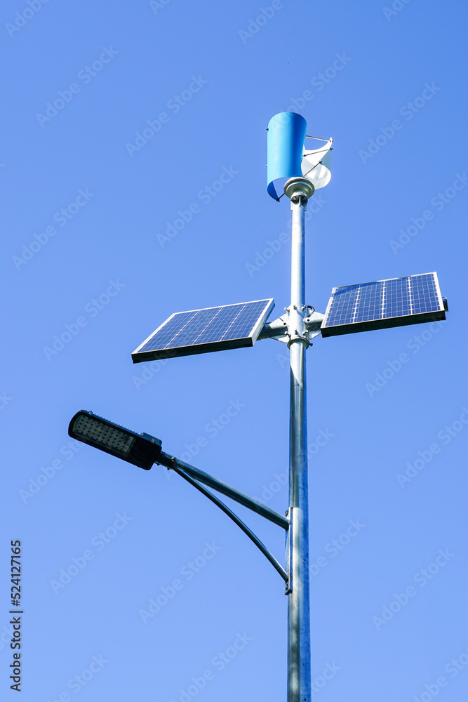 A pole with a innovative LED street light powered by solar panels and vertical wind turbine A pole with a innovative LED street light powered by solar panels and vertical wind turbine