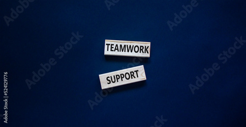 Teamwork support symbol. Concept words Teamwork support on wooden blocks on a beautiful black table black background. Business and teamwork support concept. Copy space.