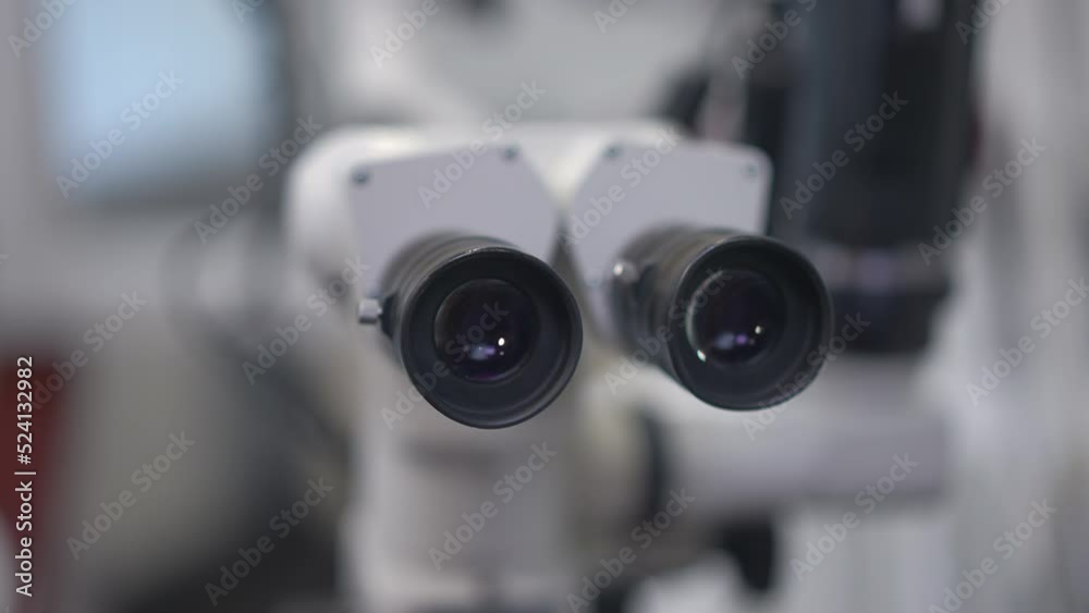 Front view close-up dental microscope eye piece with no people. High-quality modern equipment in dental clinic indoors. Slow motion