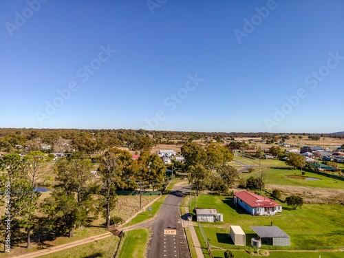 Drone shot of a neighbourhood in Emmaville, Australia with beautiful nature, hills and a roadway photo