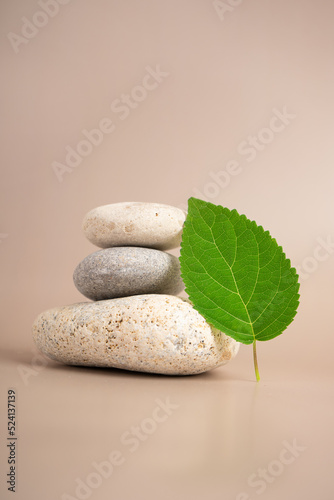 Pyramid of sea pebbles. Isolated on a beige background. The concept of life balance and harmony