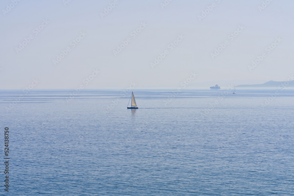 The lonely sailboat on the horizon in sea. close up