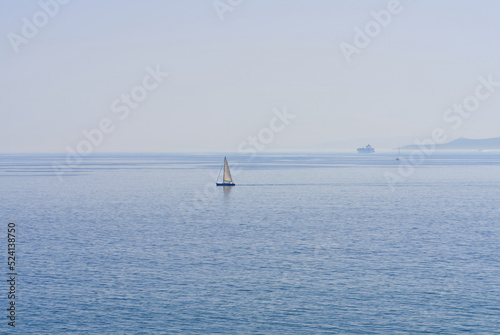 The lonely sailboat on the horizon in sea. close up