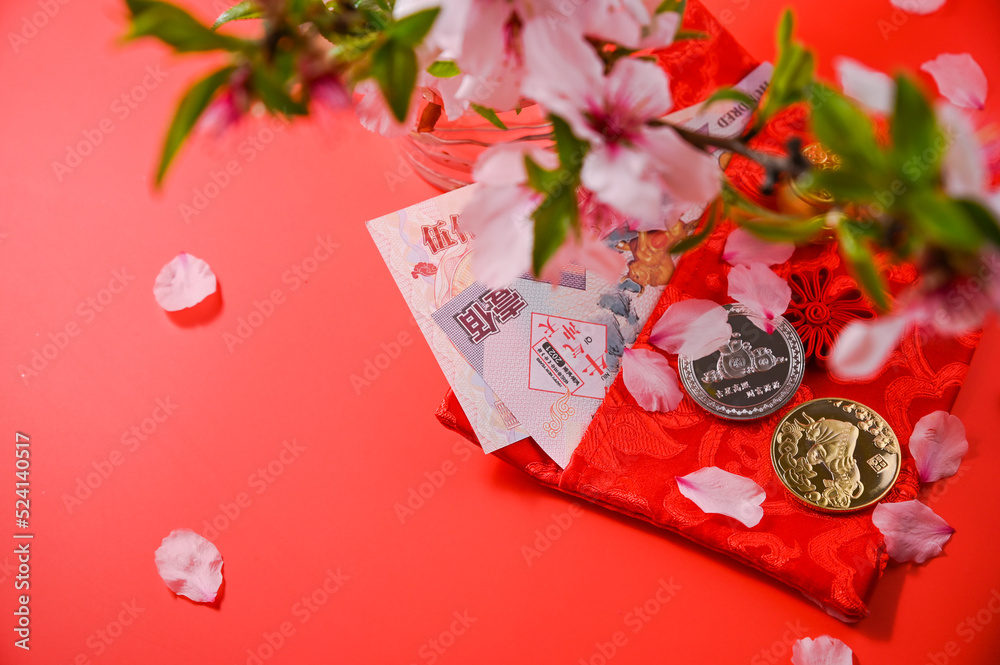 chinese new year festival decoration pow or red pack, orange and gold ingots or golden wad on red background. Chinese characters, cash flow.Year of the rabbit according the eastern calendar.Copy space chinese new year festival decoration pow or red pack, orange and gold ingots or golden wad on red background. Chinese characters, cash flow.Year of the rabbit according the eastern calendar.Copy space