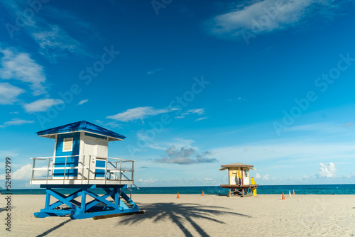 Lifeguard house on Hollywood beach in Florida, clean sand with ocean and blue sky in the background. © Junin Cantador