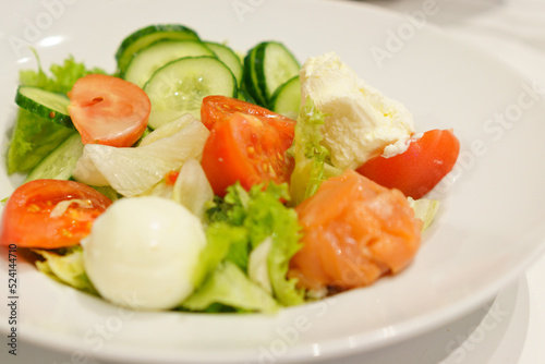 Salad made from cucumbers, tomatoes, eggs, and cabbage inside a white plate. Whole. Vitamin. Yellow. Dish. Onion. Ripe. Breakfast. Object. Eating. Cooked. Tomat. Bowl