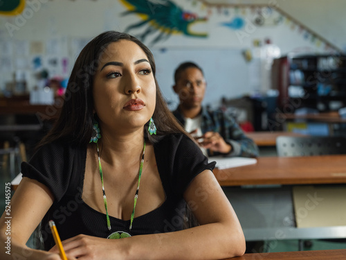 фотографія Native boy looks at Native girl in class from behind