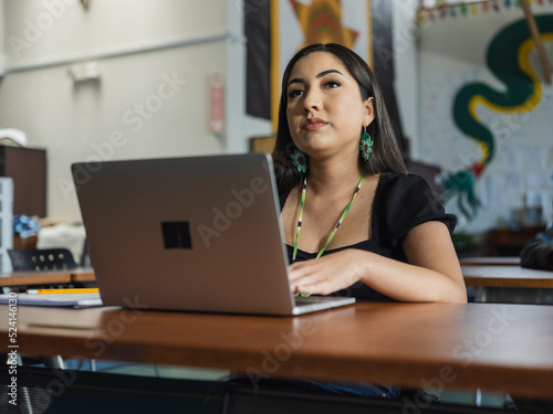 Close-up of Native girl student on her computer during class while looking up