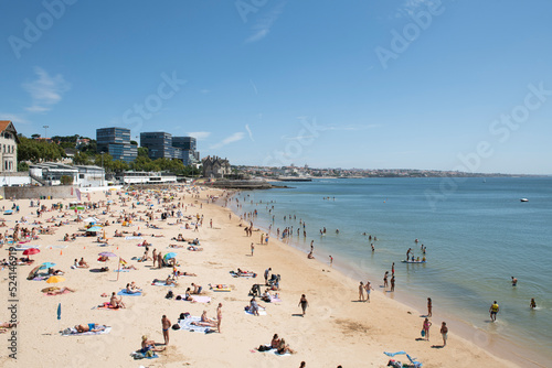Estoril beach full of bathers on a clear summer day © Toyakisfoto.photos