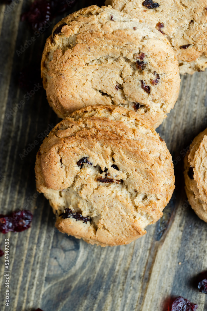delicious dried cookies made of high-quality flour with dried red cranberries on the table delicious dried cookies made of high-quality flour with dried red cranberries on the table