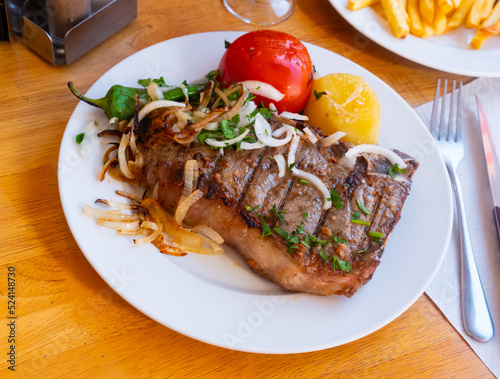Tasty and healthy grilled beef chop dinner served with vegetable garnish..