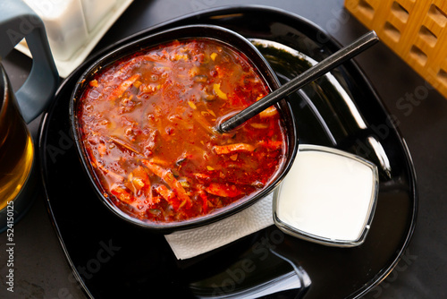 Traditional Russian dish is Solyanka soup, cooked on a steep meat broth. Served with sour cream
