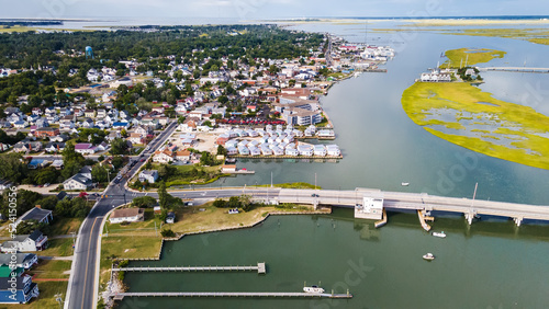 View of Chincoteague Island and the road along the bay. houses and motels with parking lots. View from above photo