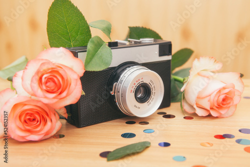 Old film camera with roses flowers, beautiful vintage card