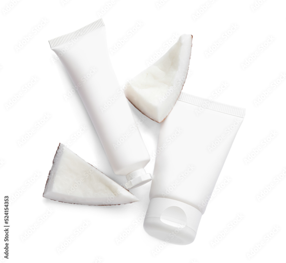 Tubes of hand cream and coconut pieces on white background, top view Tubes of hand cream and coconut pieces on white background, top view