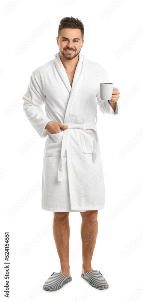 Handsome man in bathrobe with cup of coffee on white background Handsome man in bathrobe with cup of coffee on white background
