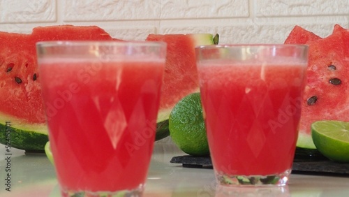 Watermelon drink, juice, lemonade with lemon and fresh mint leaves. Refreshing summer drink. DEtox healthy beverage, watermelon smoothie photo