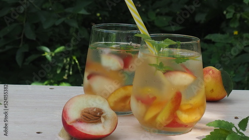 Summer drinks, with mint and peach cocktails with ice in glasses. Refreshing summer homemade Alcoholic or non-alcoholic cocktailsor Detox infused flavored water photo