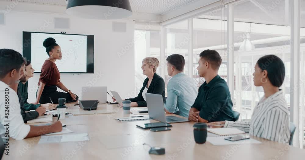 Professional business leadership presentation in global creative agency boardroom office meeting, talking about project strategy. Diverse group of colleagues sitting at table, pay attention to coach.