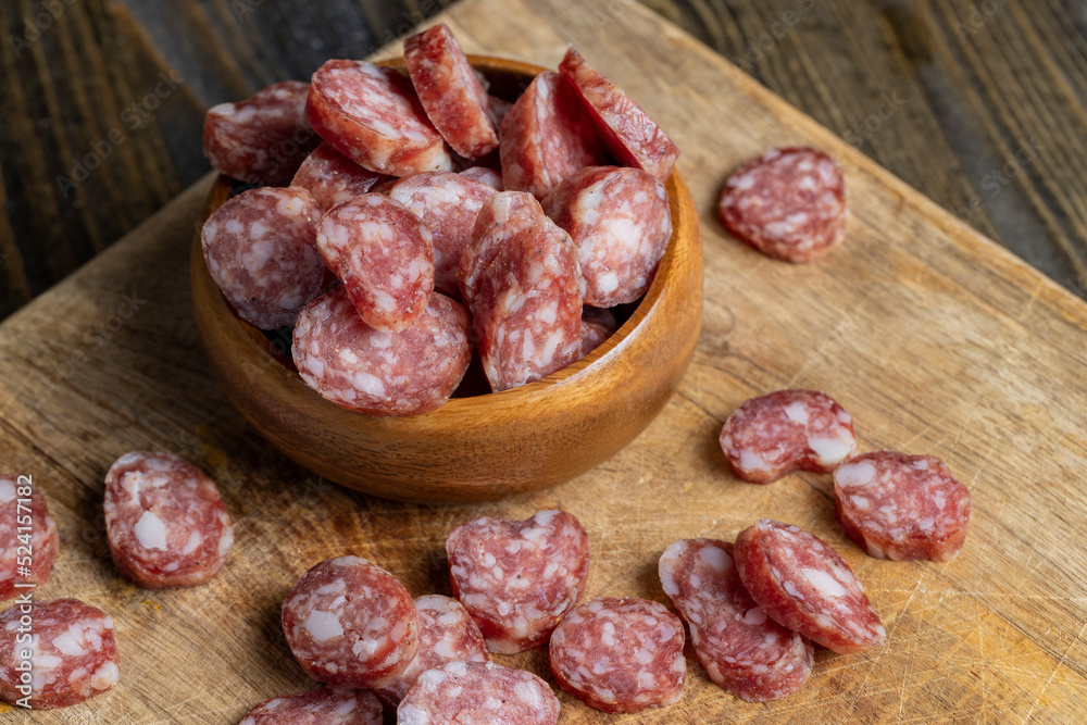 sliced thin sausage with bacon on a wooden dish sliced thin sausage with bacon on a wooden dish