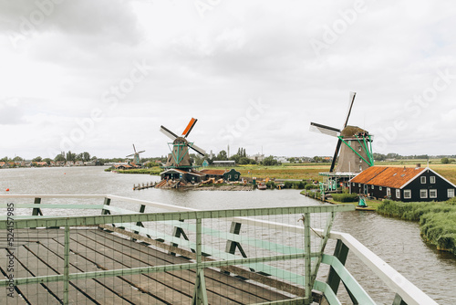 Rural landscape with windmill in Zaanse Schans. Holland, Netherlands. Authentic Zaandam mill.