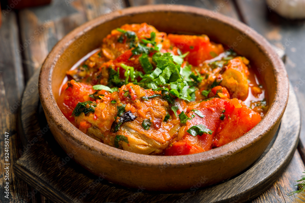 Chakhokhbili with chicken and vegetables Georgian cuisine top view on old wooden table