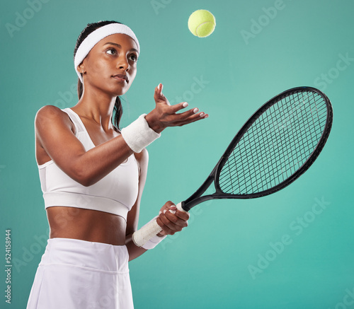 Professional tennis player, sports woman isolated holding a racket ready for a game. Sporty, active and healthy athlete preparing for a serious sport competition or tournament on studio background. © Talia M/peopleimages.com