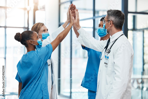 Covid doctors and nurses high five for teamwork success, collaboration and support in a hospital. Medical and healthcare professionals motivation, unity and community ready to work together as a team photo