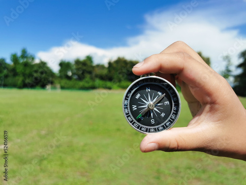holding a compass, blurry sea background Using wallpaper or travel background or navigator image