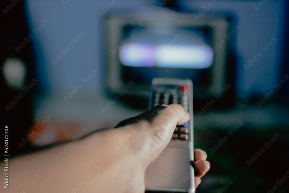 hand holding a remote control for tv hand holding a remote control for tv