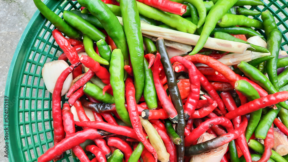  Flat Lay, Red and green curly chili in green basket