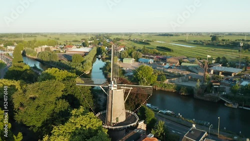 Aerial View Of Windmill Called 't Slot And Hollandse IJssel River In Gouda, Netherlands - drone shot photo