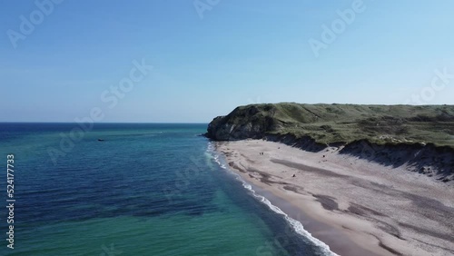 the well-known cliffs of bulbjerg on the North Sea in Denmark, with breathtakingly beautiful weather and fine white sandy beach photo