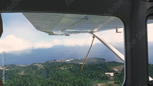 View looking through an airplane window of Cessna photo