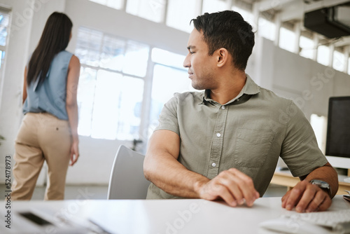 Sexual harassment, desire and suggestive business man in a office looking at a woman from behind. Male worker staring with an inappropriate, provocative look at the body of a walking female employee photo