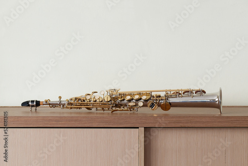 Golden Key Silver Plate Soprano Saxophone, Woodwind Instrumental Equipment on White Wall Background.