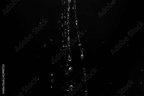 water splashes isolated on black background. white jets with drops