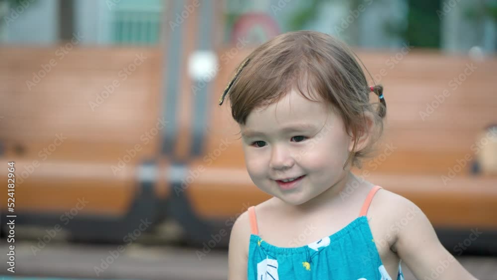 Happy active little toddler having fun dancing and jumping at an outdoor playground Happy active little toddler having fun dancing and jumping at an outdoor playground