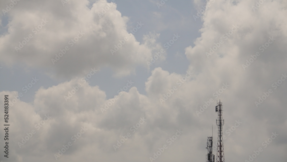 Cellular tower with Clouds in the blue sky background