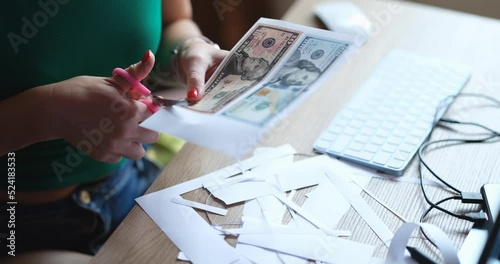 Counterfeiter cuts money printed on printer closeup photo