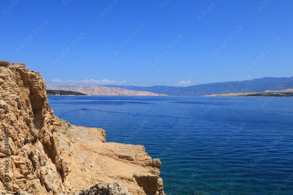 The rocky shores of the beaches in Croatia are azure blue in the Adriatic Sea

