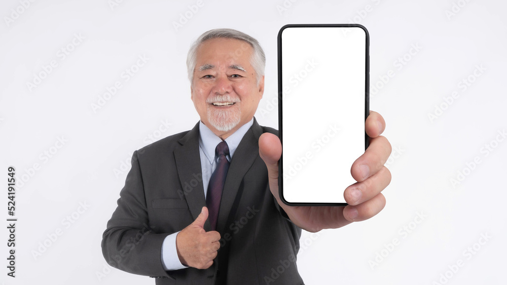 Asian senior businessman , old man with suit feel happy good health showing big smart phone with blank screen , white screen isolated on white background , Mock Up Image Asian senior businessman , old man with suit feel happy good health showing big smart phone with blank screen , white screen isolated on white background , Mock Up Image