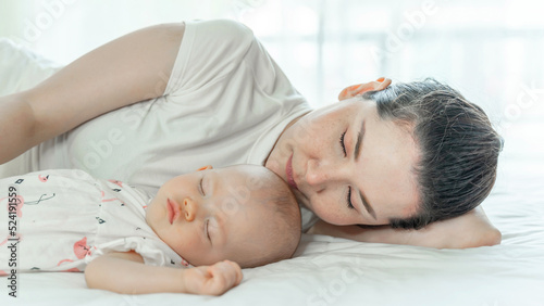 Mother with her baby sleeping on bed room