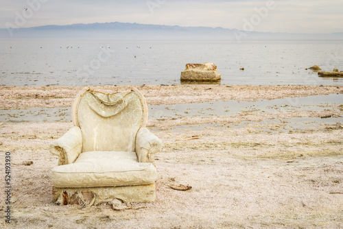 An abandon chair on the shore of Salton Sea in Southern California photo