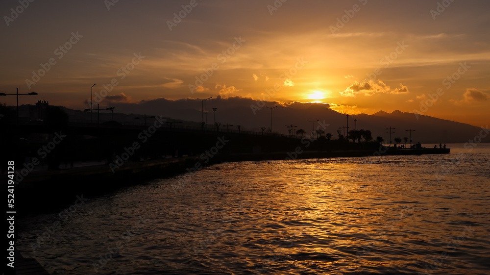 Sunset over the mountains and the coast - bay of Aegean Sea in Izmir, Turkey with copy space