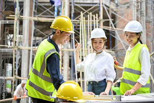 A beautiful Asian businesswoman having a outdoor meeting with engineers.