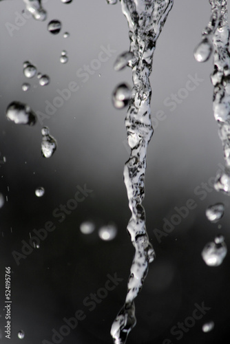 Close up of water rain drops against a grey background